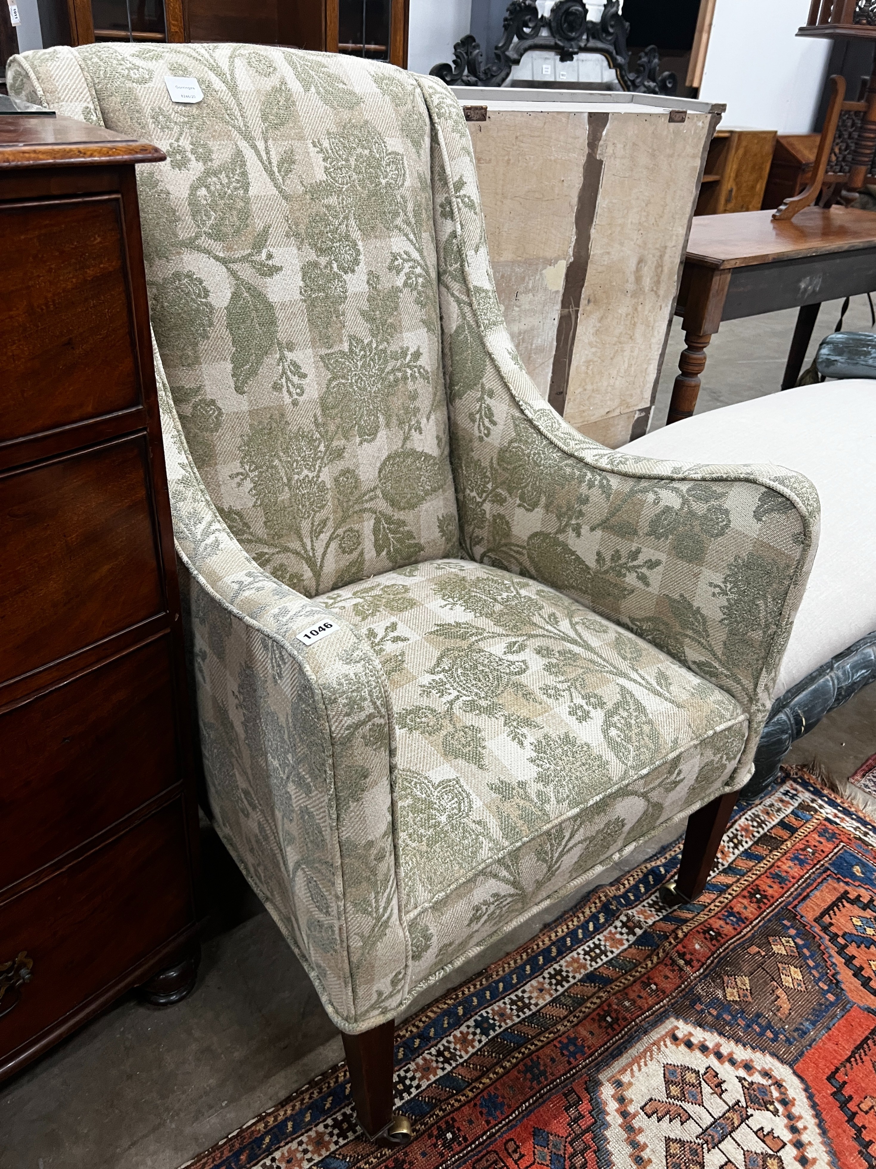 A 19th century wing armchair upholstered in patterned green floral fabric, width 68cm, depth 75cm, height 110cm